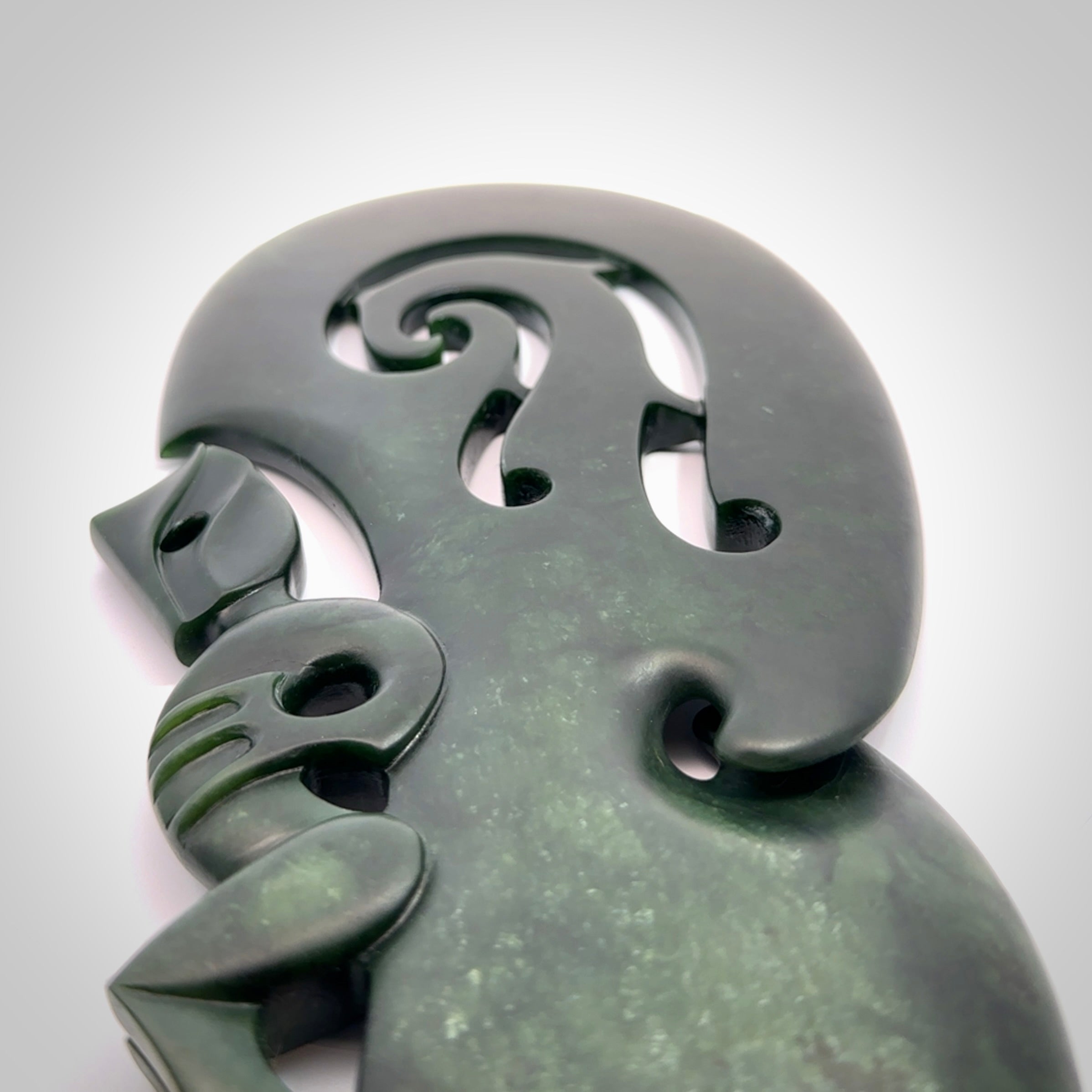 Hand carved wahaika Pounamu. Art to display. One only hand made wahaika display piece with base. New Zealand wahaika carved in Pounamu, Jade by Kerry Thompson. Free delivery worldwide.