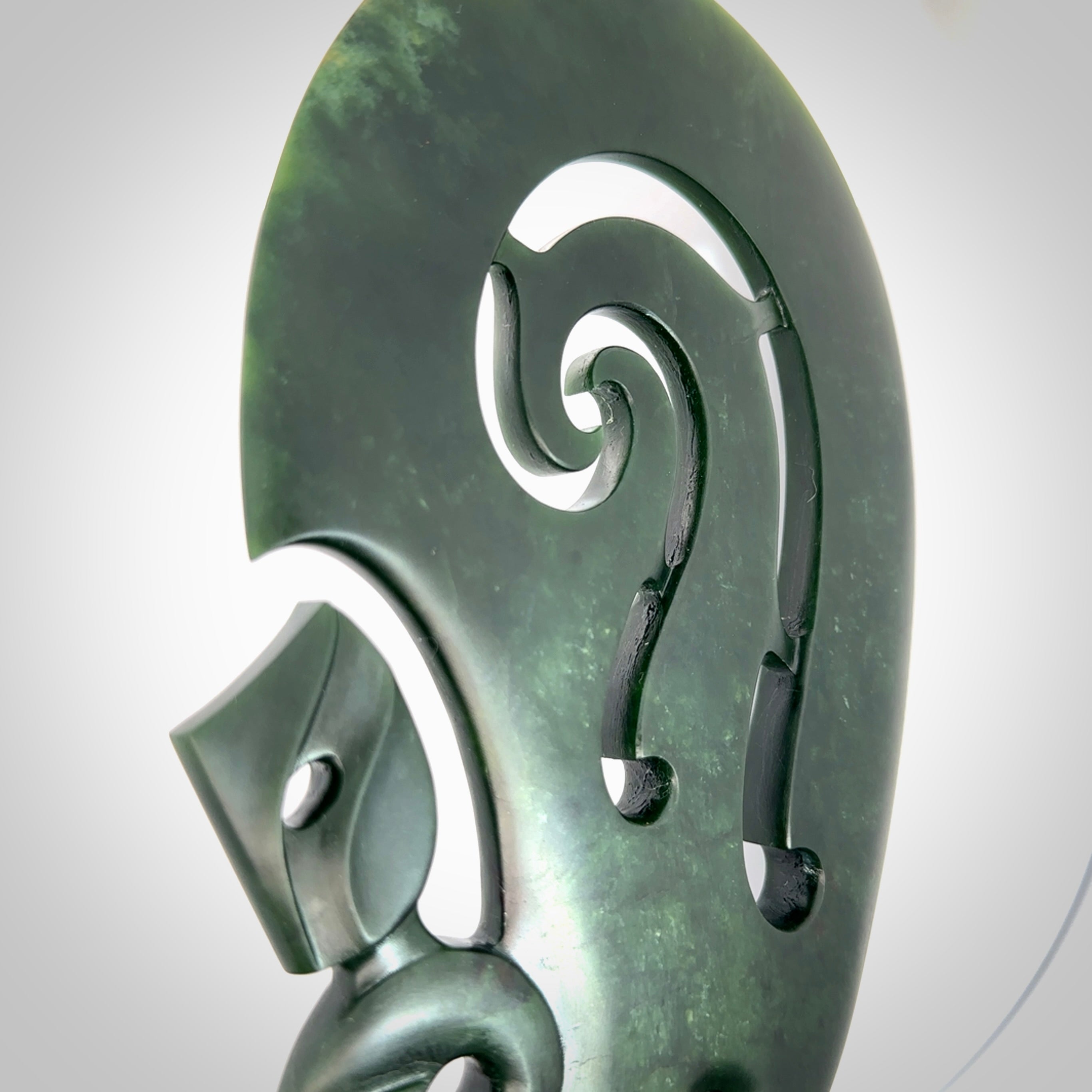 Hand carved wahaika Pounamu. Art to display. One only hand made wahaika display piece with base. New Zealand wahaika carved in Pounamu, Jade by Kerry Thompson. Free delivery worldwide.