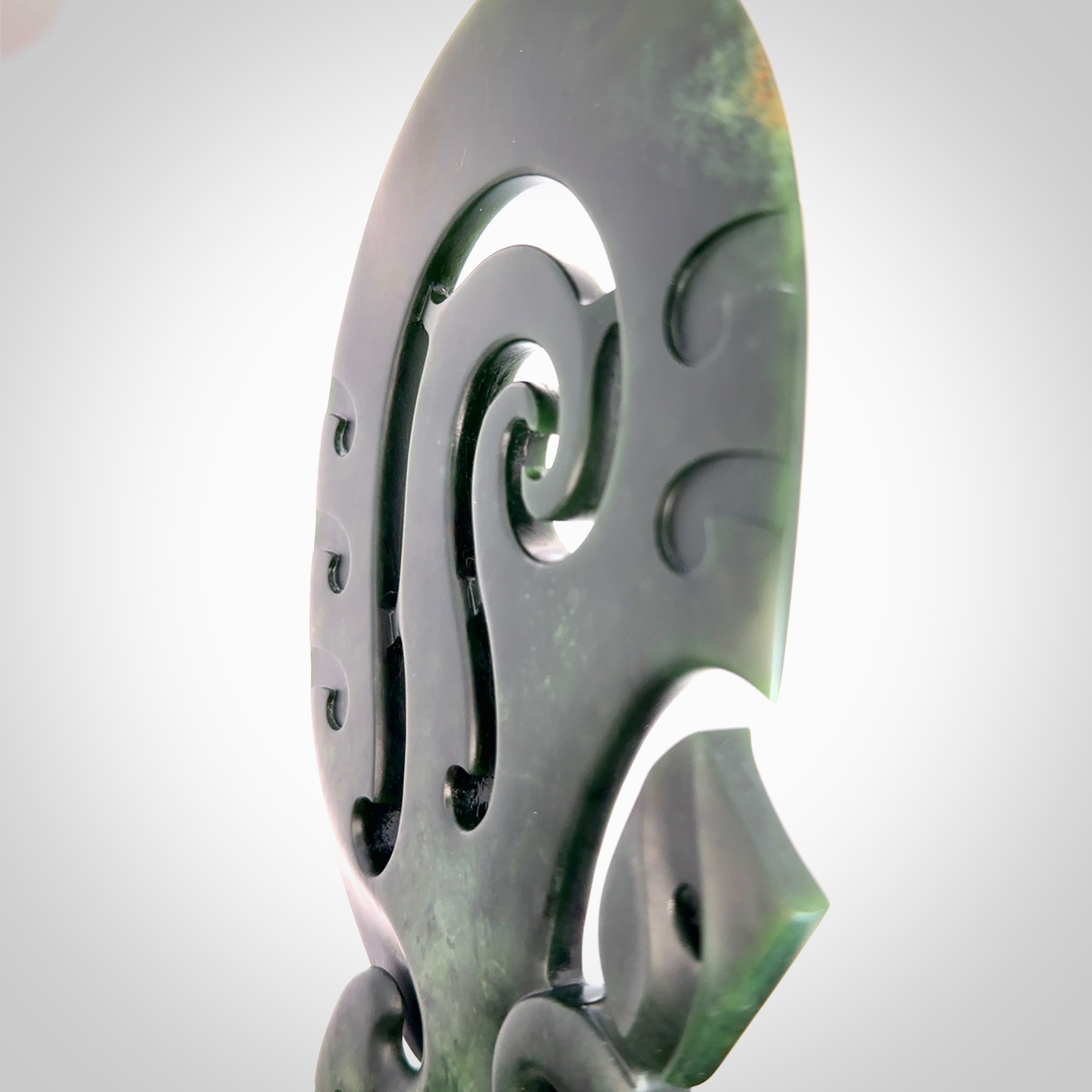 Hand carved wahaika Pounamu. Art to display. One only hand made wahaika display piece with base. New Zealand wahaika carved in Pounamu, Jade by Kerry Thompson. Free delivery worldwide.