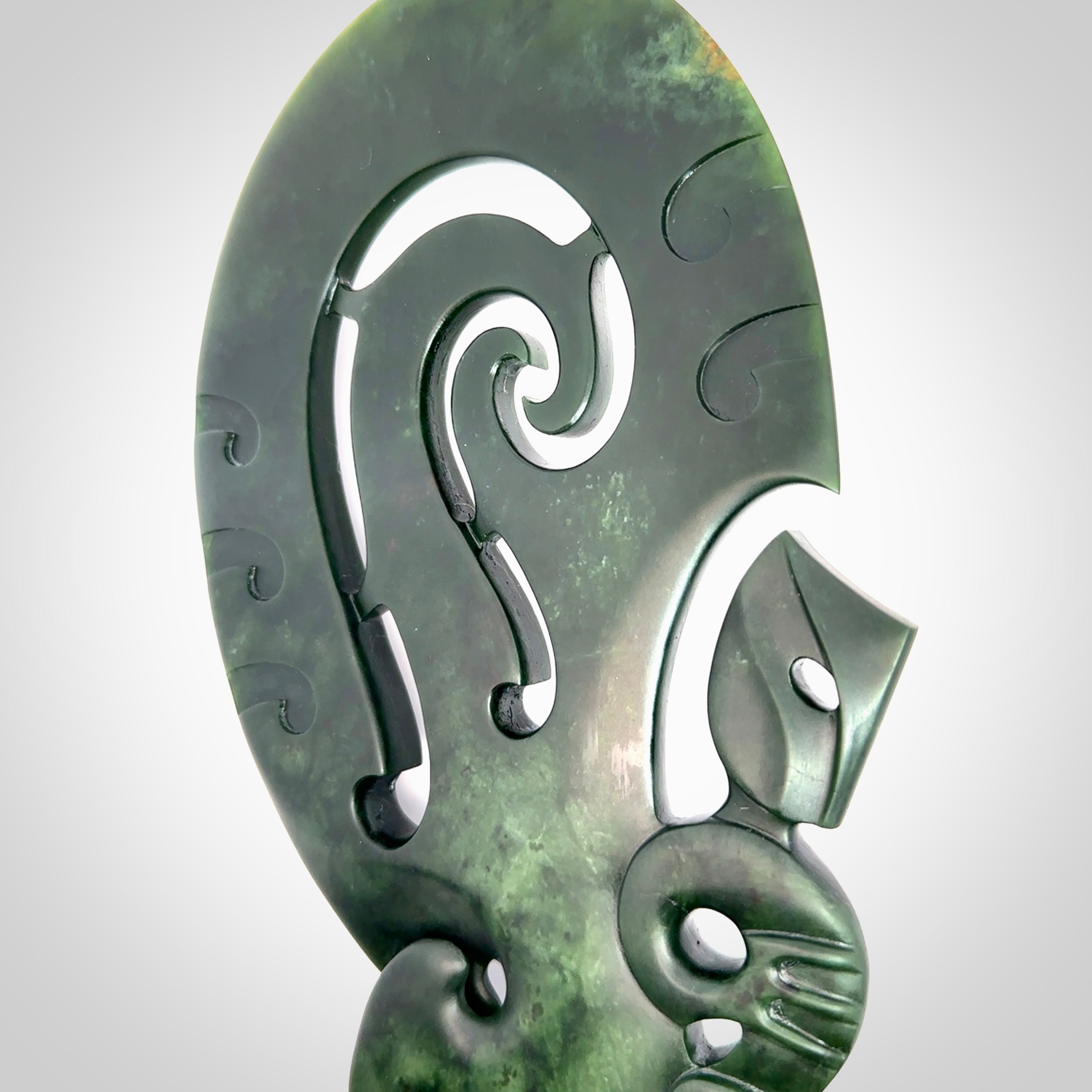 Hand carved wahaika Pounamu. Art to display. One only hand made wahaika display piece with base. New Zealand wahaika carved in Pounamu, Jade by Kerry Thompson. Free delivery worldwide.