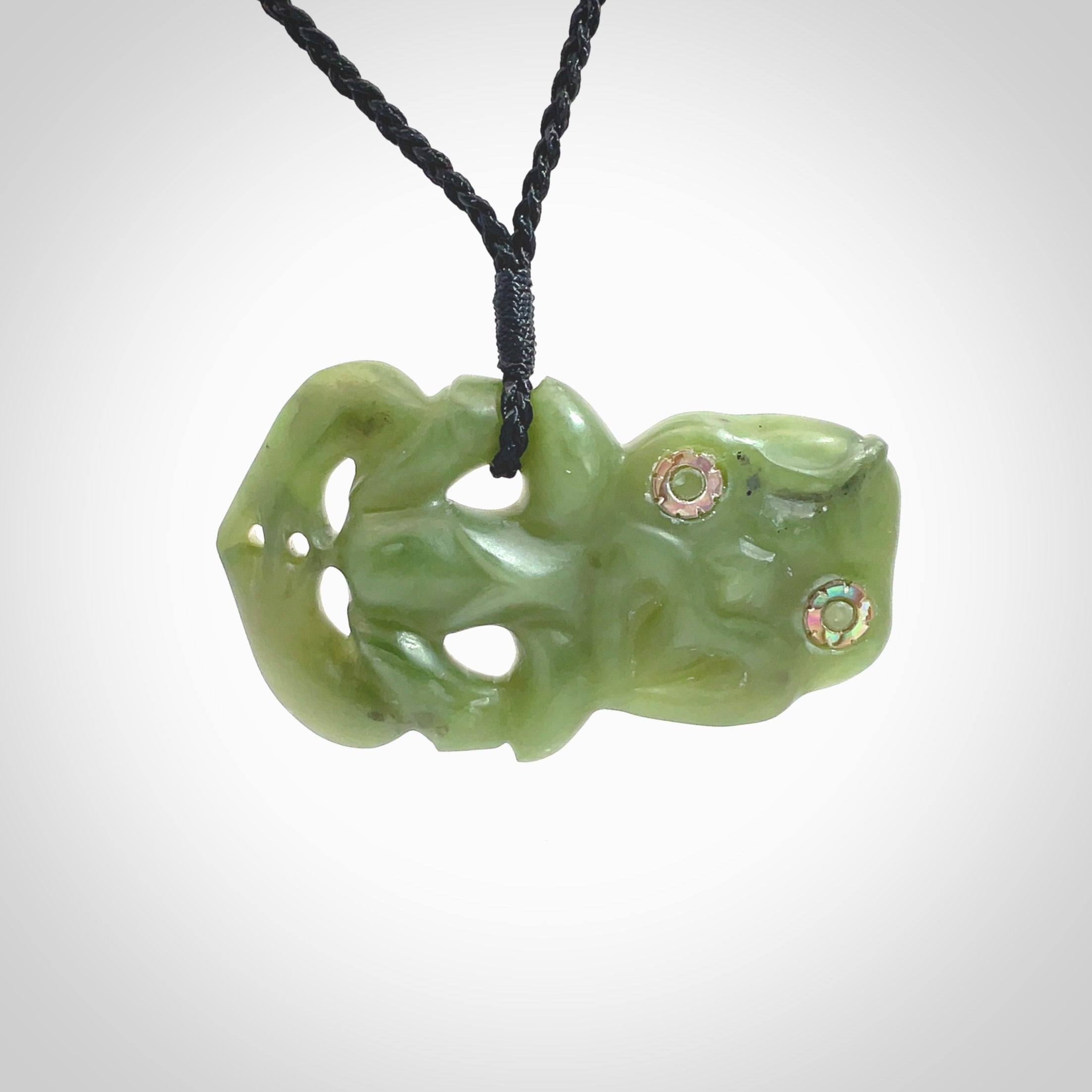 This is a large sized tiki - carved from gorgeous Marsden jade. The craftsmanship is superb, this piece is as well carved as any we have seen. The cord is an adjustable thick black and we packaged this gorgeous Pounamu Tiki in a woven kete pouch.