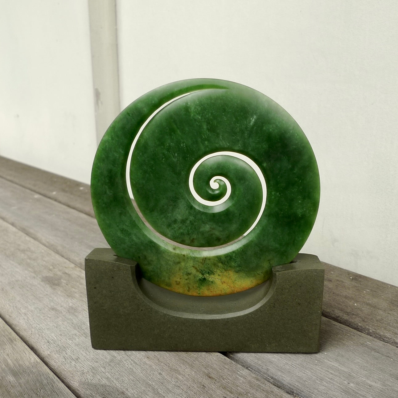 Hand carved large New Zealand Flower Jade Koru with Greywacke stand sculpture. Hand carved here in New Zealand by Ric Moor. This is a 'one only' sculpture, a beautiful display piece.