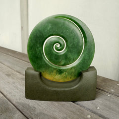 Hand carved large New Zealand Flower Jade Koru with Greywacke stand sculpture. Hand carved here in New Zealand by Ric Moor. This is a 'one only' sculpture, a beautiful display piece.