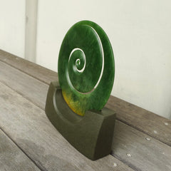 Hand carved large New Zealand Flower Jade Koru with Greywacke stand sculpture. Hand carved here in New Zealand by Ric Moor. This is a 'one only' sculpture, a beautiful display piece.