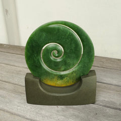 Hand carved large New Zealand Flower Jade Koru with Greywacke stand sculpture. Hand carved here in New Zealand by Ric Moor. This is a 'one only' sculpture, a beautiful display piece.