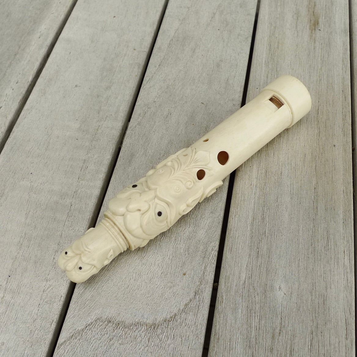 A contemporary hand carved flute. This piece is made from bone and is a fully functioning musical instrument and can be played. Beautiful art hand made by Yuri Terenyi. Flute with Dragons head.