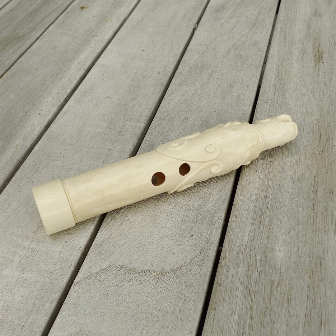 A contemporary hand carved flute. This piece is made from bone and is a fully functioning musical instrument and can be played. Beautiful art hand made by Yuri Terenyi. Flute with Dragons head.