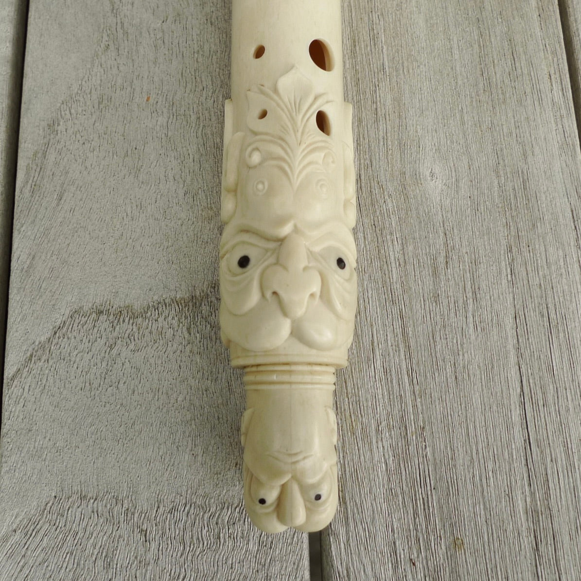 A contemporary hand carved flute. This piece is made from bone and is a fully functioning musical instrument and can be played. Beautiful art hand made by Yuri Terenyi. Flute with Dragons head.