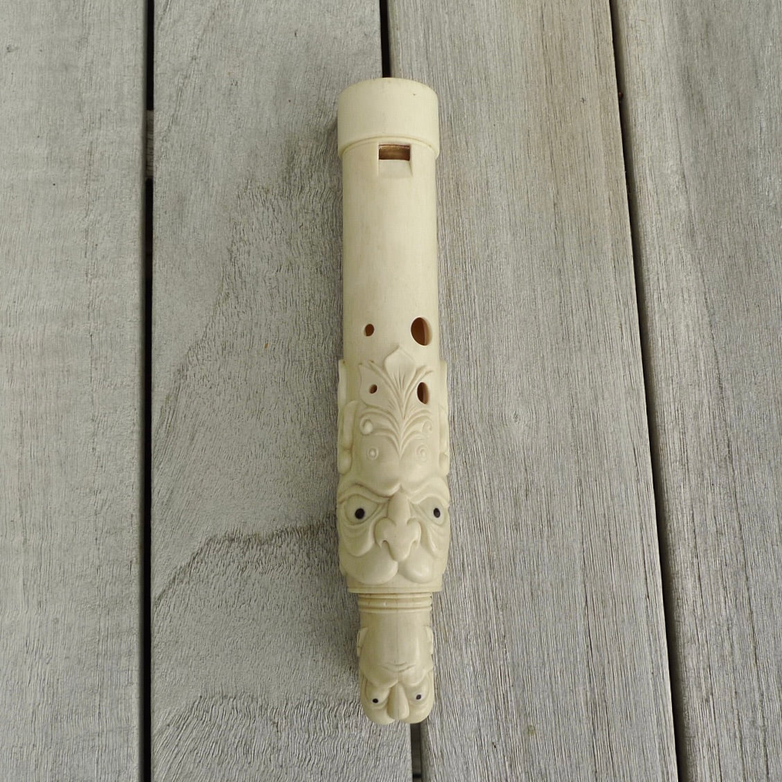 A contemporary hand carved flute. This piece is made from bone and is a fully functioning musical instrument and can be played. Beautiful art hand made by Yuri Terenyi. Flute with Dragons head.