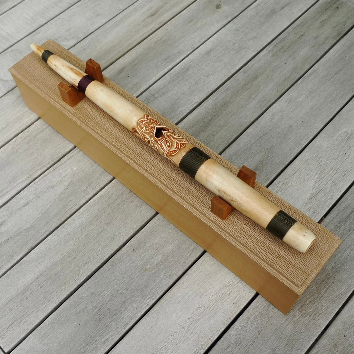 A traditional hand carved Māori flute. This piece is made from bone and is a fully functioning musical instrument and can be played. Beautiful ethnic art hand made by NZ Pacific. One off flute hand made by Yuri Terenyi.