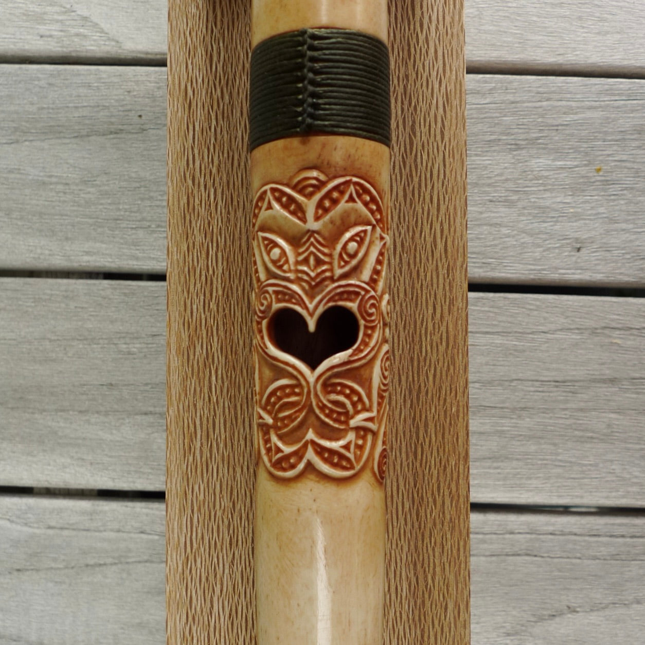 A traditional hand carved Māori flute. This piece is made from bone and is a fully functioning musical instrument and can be played. Beautiful ethnic art hand made by NZ Pacific. One off flute hand made by Yuri Terenyi.