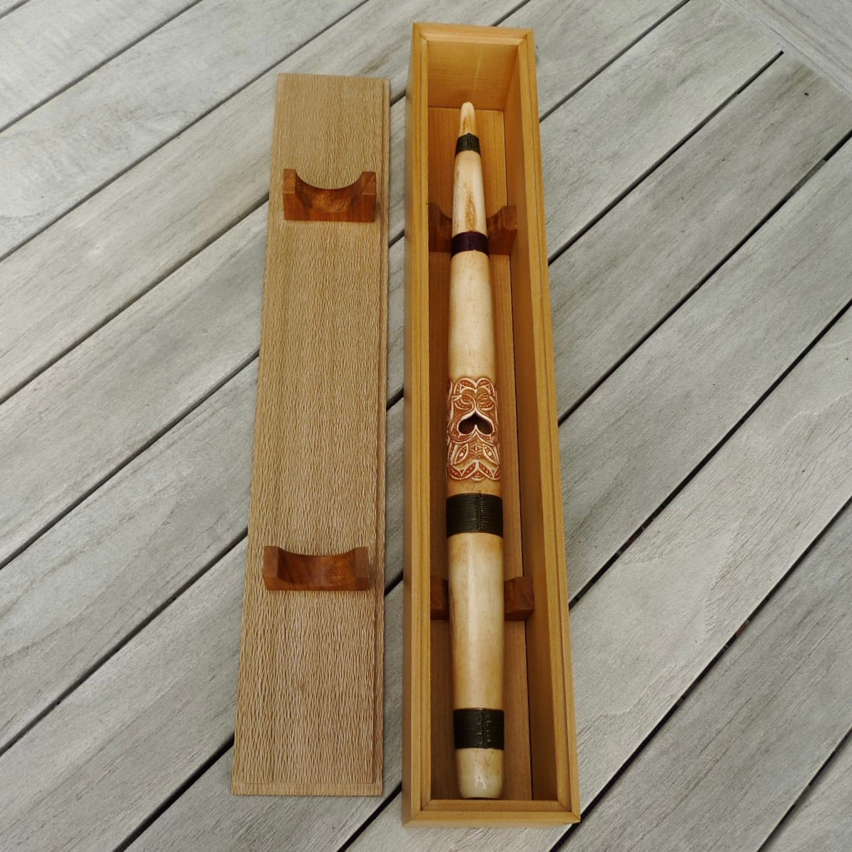 A traditional hand carved Māori flute. This piece is made from bone and is a fully functioning musical instrument and can be played. Beautiful ethnic art hand made by NZ Pacific. One off flute hand made by Yuri Terenyi.