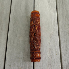 A traditional hand carved Māori flute. This piece is made from bone and is a fully functioning musical instrument and can be played. Beautiful ethnic art hand made by NZ Pacific. Hand made by Yuri Terenyi, one only stained bone flute instrument. Traditional art from New Zealand.