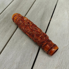 A traditional hand carved Māori flute. This piece is made from bone and is a fully functioning musical instrument and can be played. Beautiful ethnic art hand made by NZ Pacific. Hand made by Yuri Terenyi, one only stained bone flute instrument. Traditional art from New Zealand.