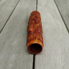 A traditional hand carved Māori flute. This piece is made from bone and is a fully functioning musical instrument and can be played. Beautiful ethnic art hand made by NZ Pacific. Hand made by Yuri Terenyi, one only stained bone flute instrument. Traditional art from New Zealand.