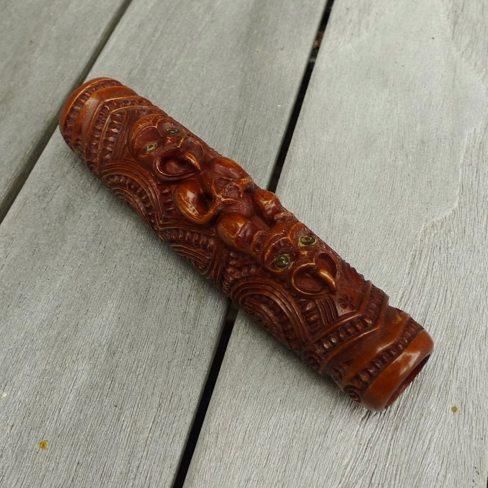 A traditional hand carved Māori flute. This piece is made from stained bone and is a fully functioning musical instrument and can be played. Beautiful ethnic art hand made by NZ Pacific. Hand carved by Yuri Terenyi.