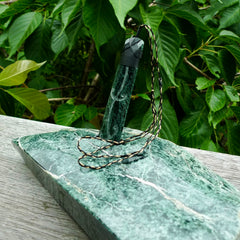 Large New Zealand Tangiwai Pounamu Toki pendant with Tangiwai boulder display case. Hand carved from a lovely piece of local New Zealand Tangiwai Stone. The quality of the workmanship and design is outstanding - this is a piece you will want to wear all the time. We have suspended this from an adjustable 3-plait tan/black cord.