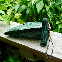 Large New Zealand Tangiwai Pounamu Toki pendant with Tangiwai boulder display case. Hand carved from a lovely piece of local New Zealand Tangiwai Stone. The quality of the workmanship and design is outstanding - this is a piece you will want to wear all the time. We have suspended this from an adjustable 3-plait tan/black cord.