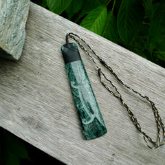 Large New Zealand Tangiwai Pounamu Toki pendant with Tangiwai boulder display case. Hand carved from a lovely piece of local New Zealand Tangiwai Stone. The quality of the workmanship and design is outstanding - this is a piece you will want to wear all the time. We have suspended this from an adjustable 3-plait tan/black cord.