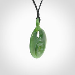 New Zealand Jade twist with koru pendant. Hand carved from rare New Zealand jade this is a beautiful pounamu pendant. The cord is hand plaited and is length adjustable. A very beautiful greenstone pendant. For sale online by NZ Pacific.