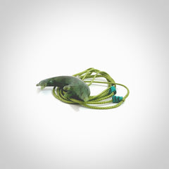 This is a gorgeous little dolphin pendant carved in green nephrite jade. The cord is a fine grass green colour and is length adjustable so you can position the little jade dolphin where it suits you best. Shipping is free worldwide.