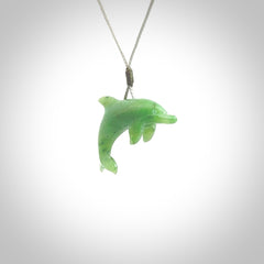 This is a gorgeous little dolphin pendant carved in green nephrite jade. The cord is a fine grey colour and is length adjustable so you can position the little jade dolphin where it suits you best. Shipping is free worldwide.