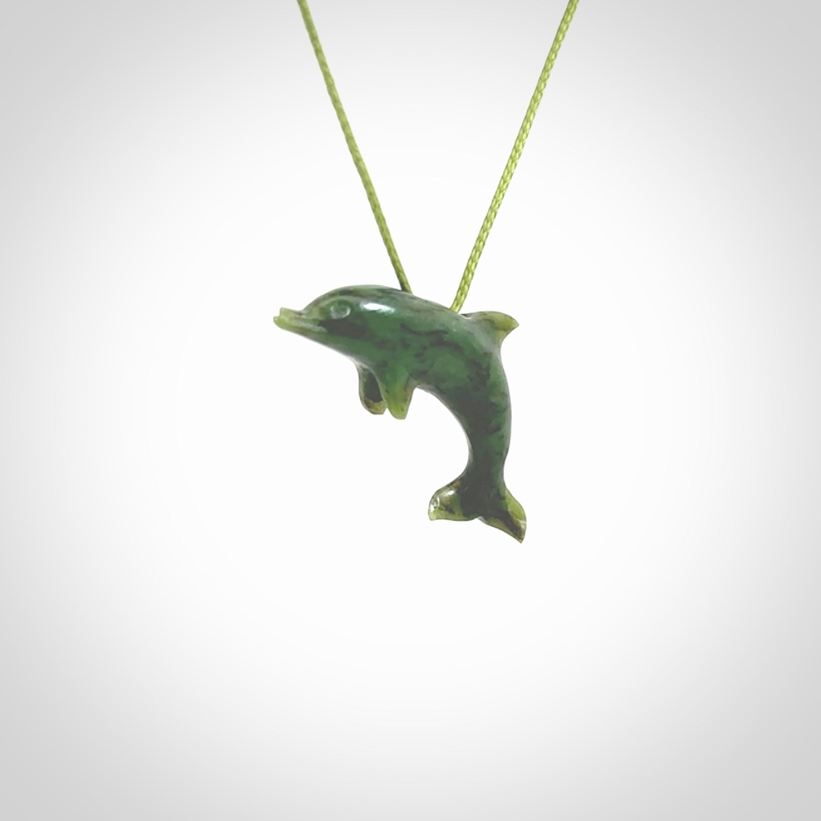 This is a gorgeous little dolphin pendant carved in green nephrite jade. The cord is a fine grass green colour and is length adjustable so you can position the little jade dolphin where it suits you best. Shipping is free worldwide.