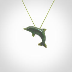 This is a gorgeous little dolphin pendant carved in green nephrite jade. The cord is a fine grass green colour and is length adjustable so you can position the little jade dolphin where it suits you best. Shipping is free worldwide.