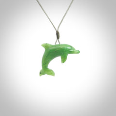 This is a gorgeous little dolphin pendant carved in green nephrite jade. The cord is a fine grey colour and is length adjustable so you can position the little jade dolphin where it suits you best. Shipping is free worldwide.