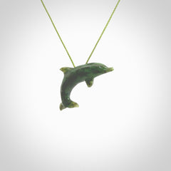 This is a gorgeous little dolphin pendant carved in green nephrite jade. The cord is a fine grass green colour and is length adjustable so you can position the little jade dolphin where it suits you best. Shipping is free worldwide.