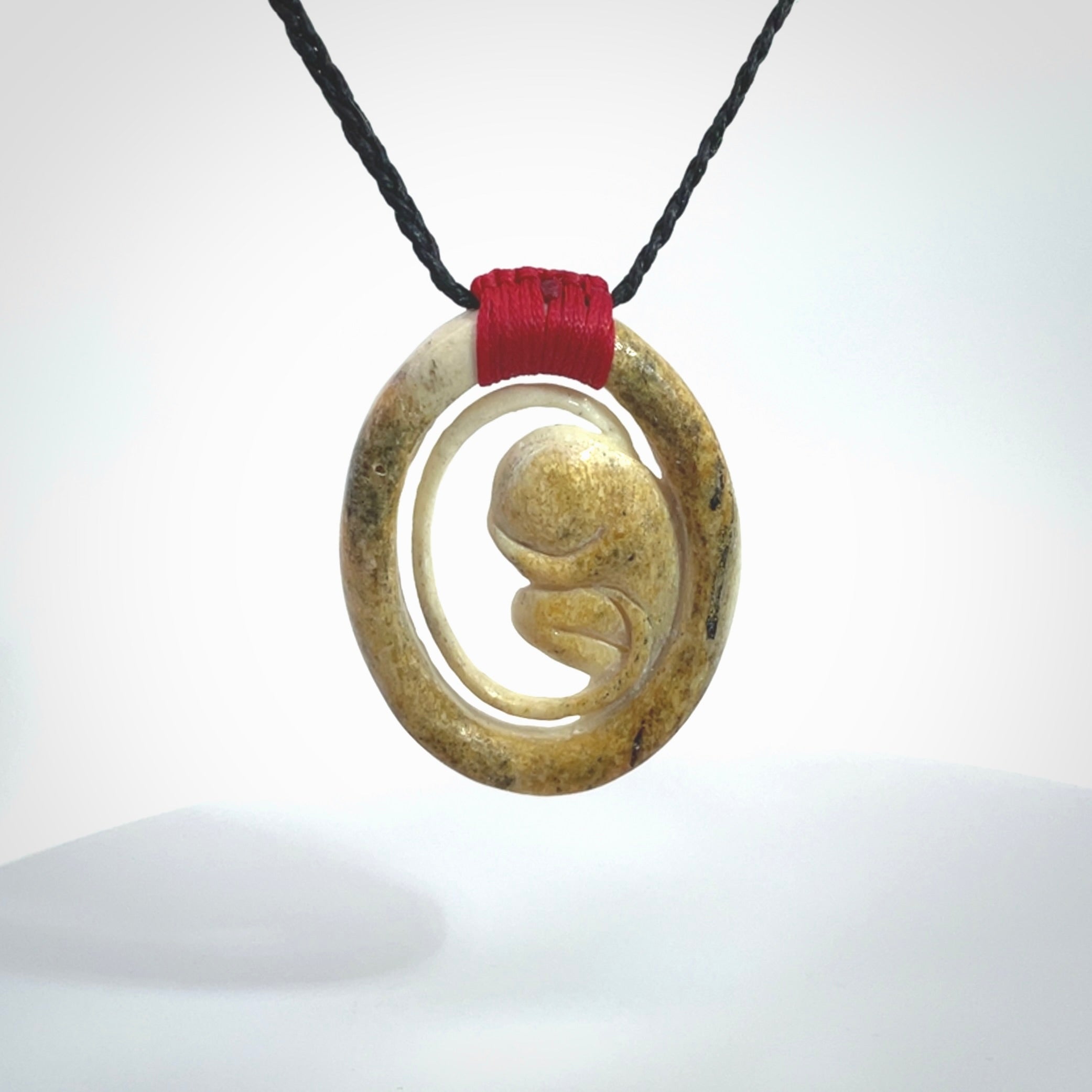 Hand carved deer antler fetus pendant. Hand carved by NZ Pacific. Free postage worldwide. Hand made fetus necklace from deer antler. Fetus necklace for men and women. Delivered with adjustable and packaged in a woven kete pouch.