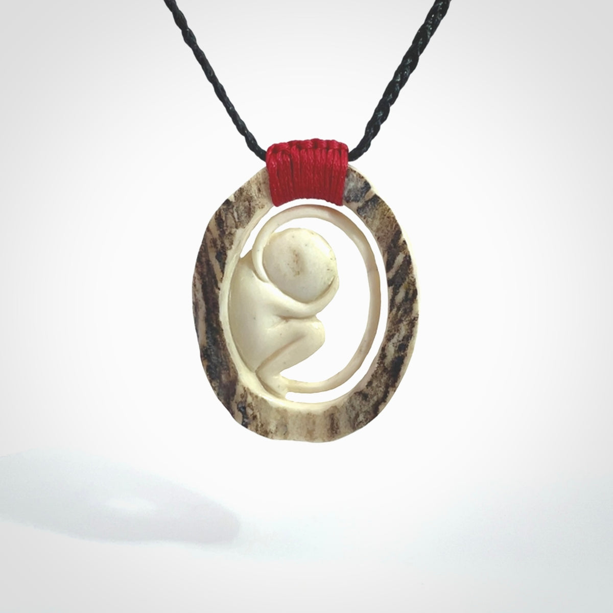 Hand carved deer antler fetus pendant. Hand carved by NZ Pacific. Free postage worldwide. Hand made fetus necklace from deer antler. Fetus necklace for men and women. Delivered with adjustable and packaged in a woven kete pouch.