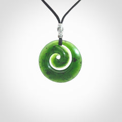 Hand carved New Zealand Kawakawa jade koru pendant. Carved for NZ Pacific by Ross Crump. Jade jewelry for sale online exclusively with NZ Pacific.