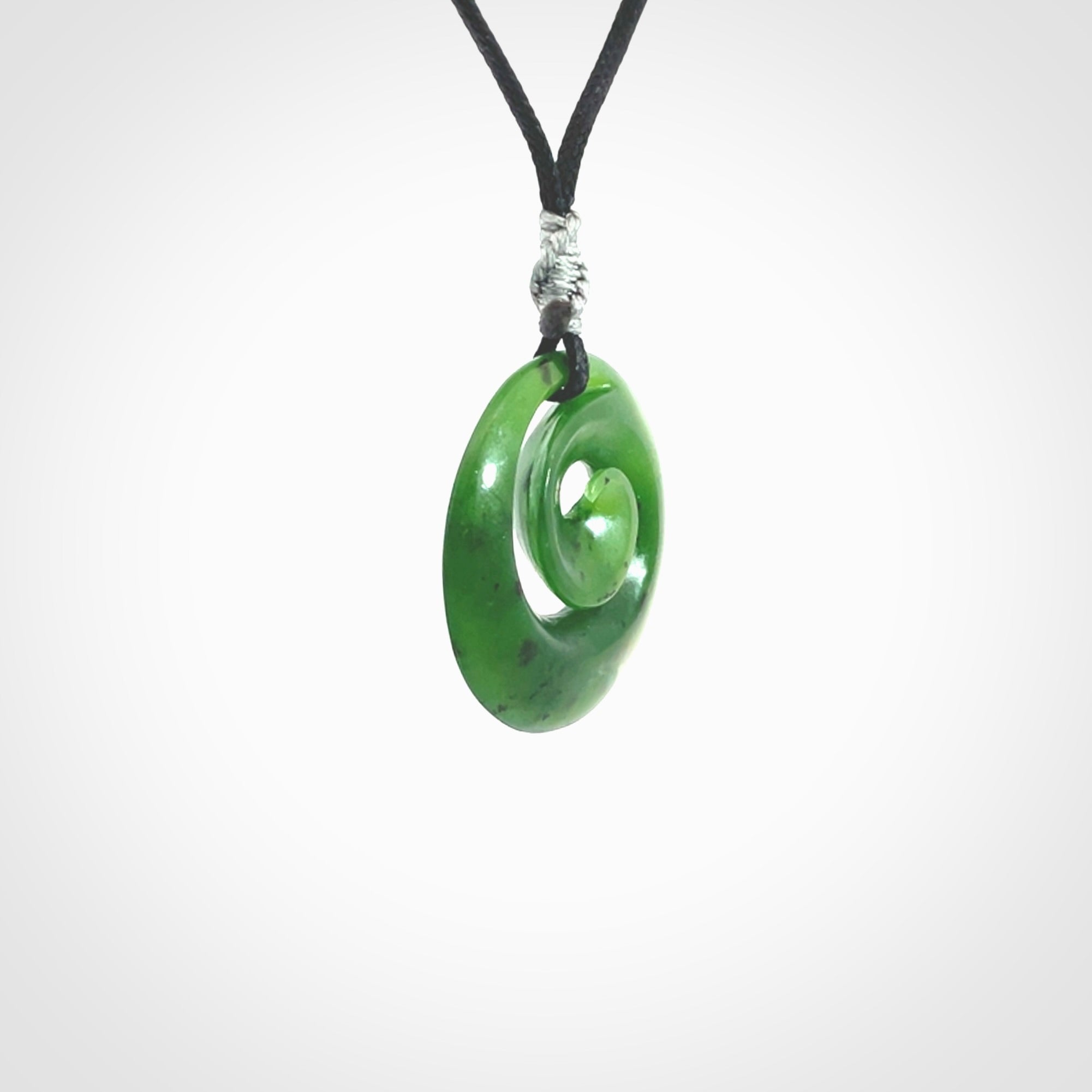 Hand carved New Zealand Kawakawa jade koru pendant. Carved for NZ Pacific by Ross Crump. Jade jewelry for sale online exclusively with NZ Pacific.