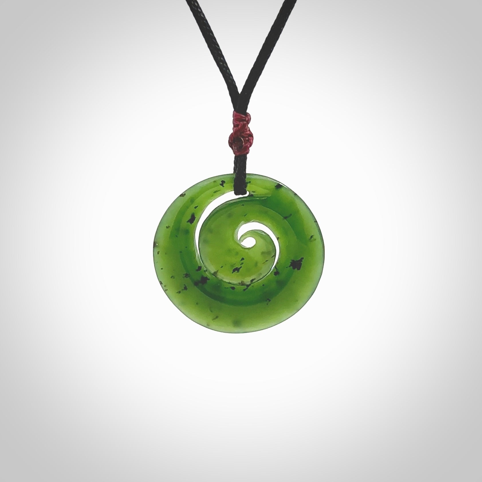 Hand carved New Zealand Kawakawa jade koru pendant. Carved for NZ Pacific by Ross Crump. Jade jewelry for sale online exclusively with NZ Pacific.