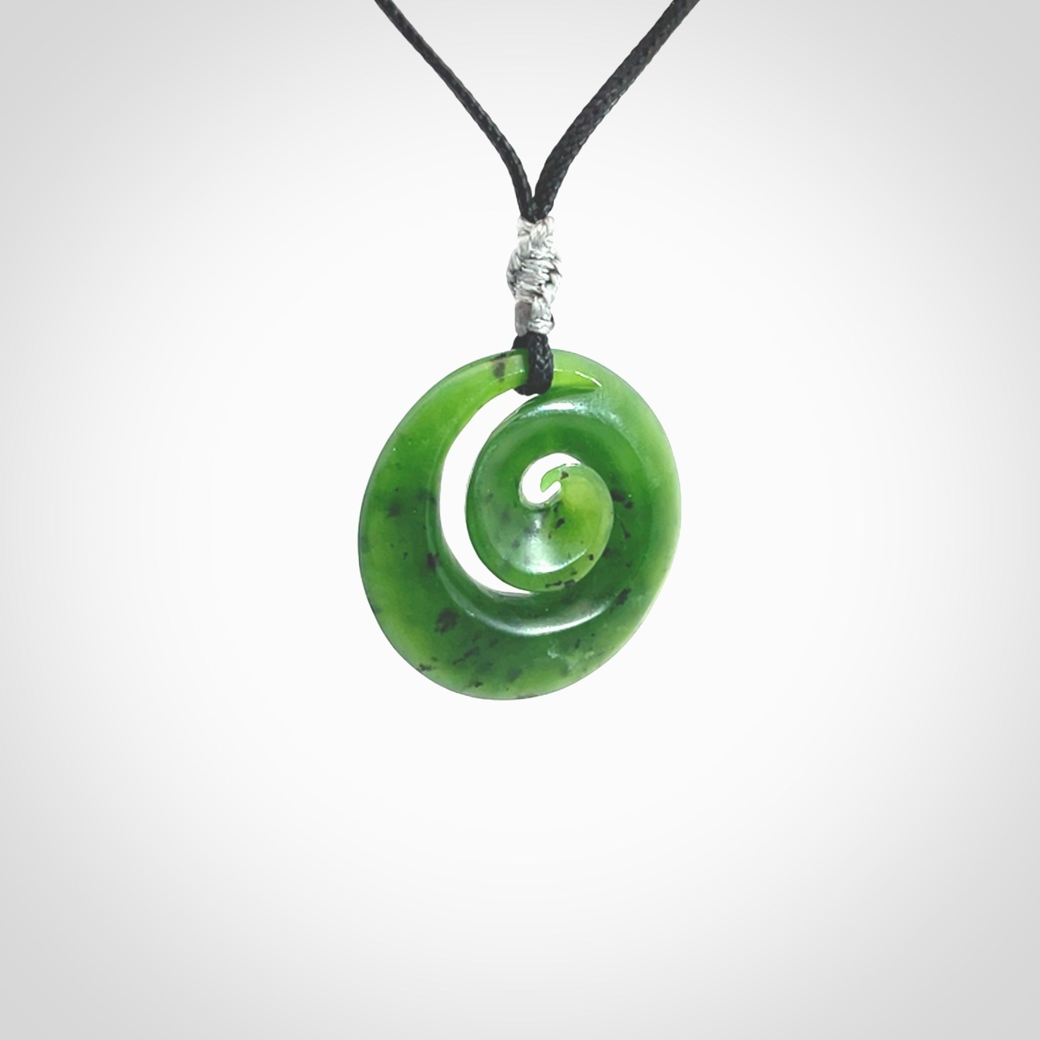 Hand carved New Zealand Kawakawa jade koru pendant. Carved for NZ Pacific by Ross Crump. Jade jewelry for sale online exclusively with NZ Pacific.