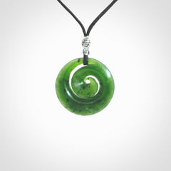 Hand carved New Zealand Kawakawa jade koru pendant. Carved for NZ Pacific by Ross Crump. Jade jewelry for sale online exclusively with NZ Pacific.