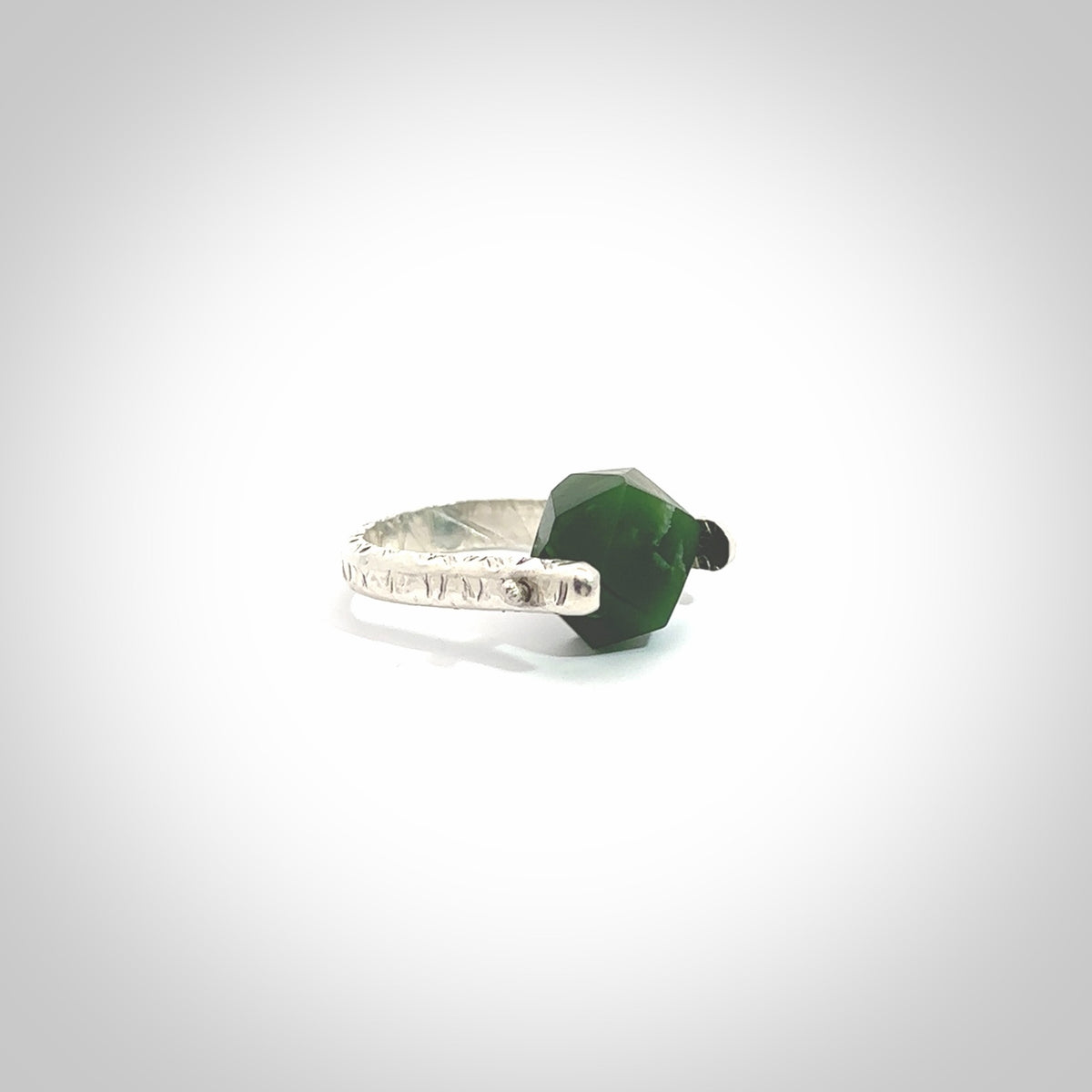 This is a handcrafted New Zealand Pounamu, Jade and sterling silver ring. This is a solid little work of art. We ship this worldwide for free and are happy to answer any questions that you may have about these or other products on our website. Hand made by Ana Krakosky.