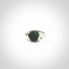 This is a handcrafted New Zealand Pounamu, Jade and sterling silver ring. This is a solid little work of art. We ship this worldwide for free and are happy to answer any questions that you may have about these or other products on our website. Hand made by Ana Krakosky.