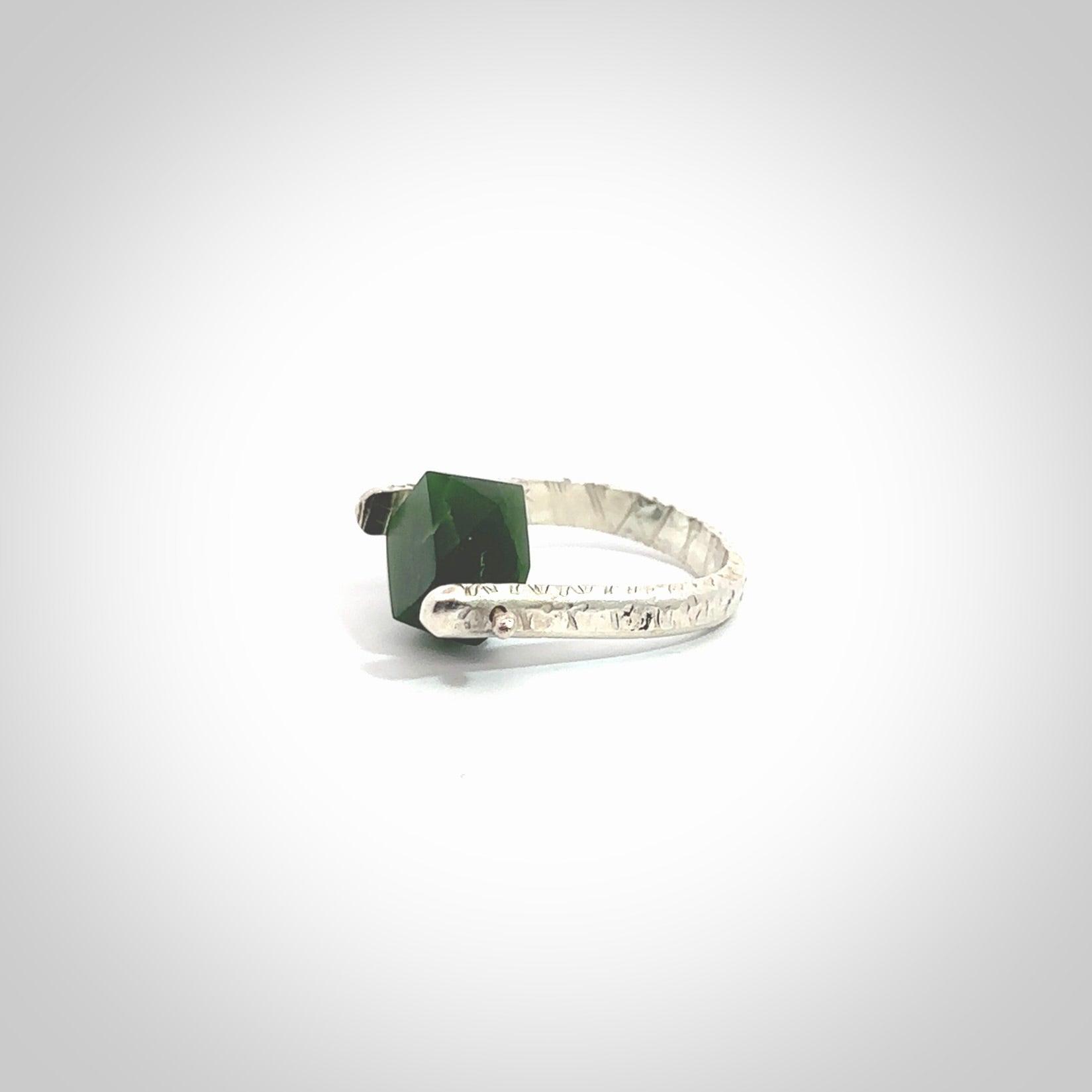 This is a handcrafted New Zealand Pounamu, Jade and sterling silver ring. This is a solid little work of art. We ship this worldwide for free and are happy to answer any questions that you may have about these or other products on our website. Hand made by Ana Krakosky.