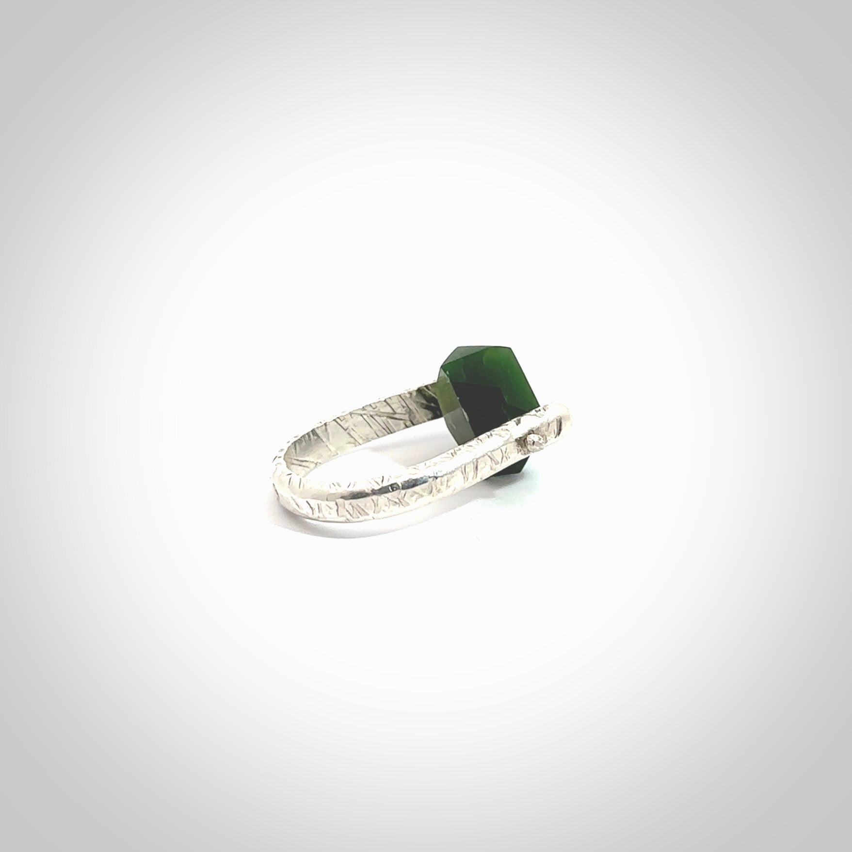 This is a handcrafted New Zealand Pounamu, Jade and sterling silver ring. This is a solid little work of art. We ship this worldwide for free and are happy to answer any questions that you may have about these or other products on our website. Hand made by Ana Krakosky.