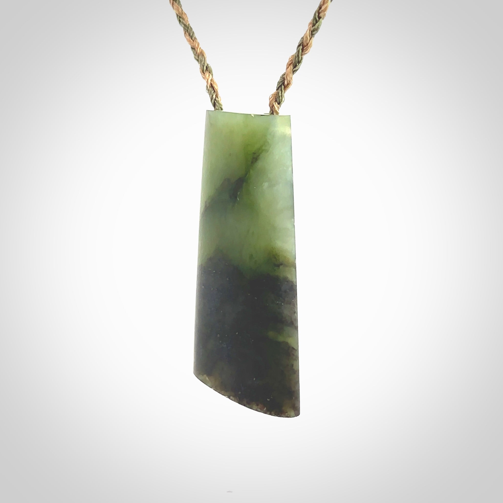 This photo shows a medium sized jade drop shaped pendant. It a a lovely, colourful douglas creek jade. The cord is a tan/green and is adjustable in length. One only large, contemporary drop necklace from Jade, by Rueben Tipene.