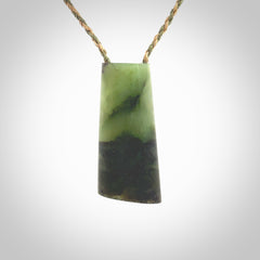 This photo shows a medium sized jade drop shaped pendant. It a a lovely, colourful douglas creek jade. The cord is a tan/green and is adjustable in length. One only large, contemporary drop necklace from Jade, by Rueben Tipene.