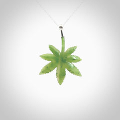 Cannabis Leaf Jade pendant with Sterling Silver Cap. Handmade jade Cannabis leaf jewellery made by NZ Pacific and for sale online. Jade Marijuana leaf pendant for men and women. Unique art to wear from NZ Pacific. Delivered on a Sterling Silver Chain.