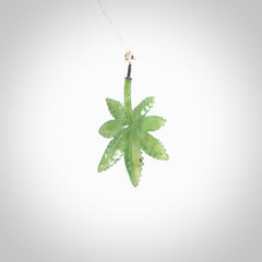 Cannabis Leaf Jade pendant with Sterling Silver Cap. Handmade jade Cannabis leaf jewellery made by NZ Pacific and for sale online. Jade Marijuana leaf pendant for men and women. Unique art to wear from NZ Pacific. Delivered on a Sterling Silver Chain.