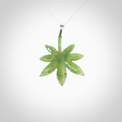 Cannabis Leaf Jade pendant with Sterling Silver Cap. Handmade jade Cannabis leaf jewellery made by NZ Pacific and for sale online. Jade Marijuana leaf pendant for men and women. Unique art to wear from NZ Pacific. Delivered on a Sterling Silver Chain.