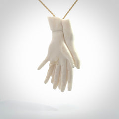 Hand carved large bone double hands with wedding rings pendant. A stunning work of art. This pendant is hand carved in bone and provided with an adjustable cord. A one off work of art to wear by NZ Pacific.