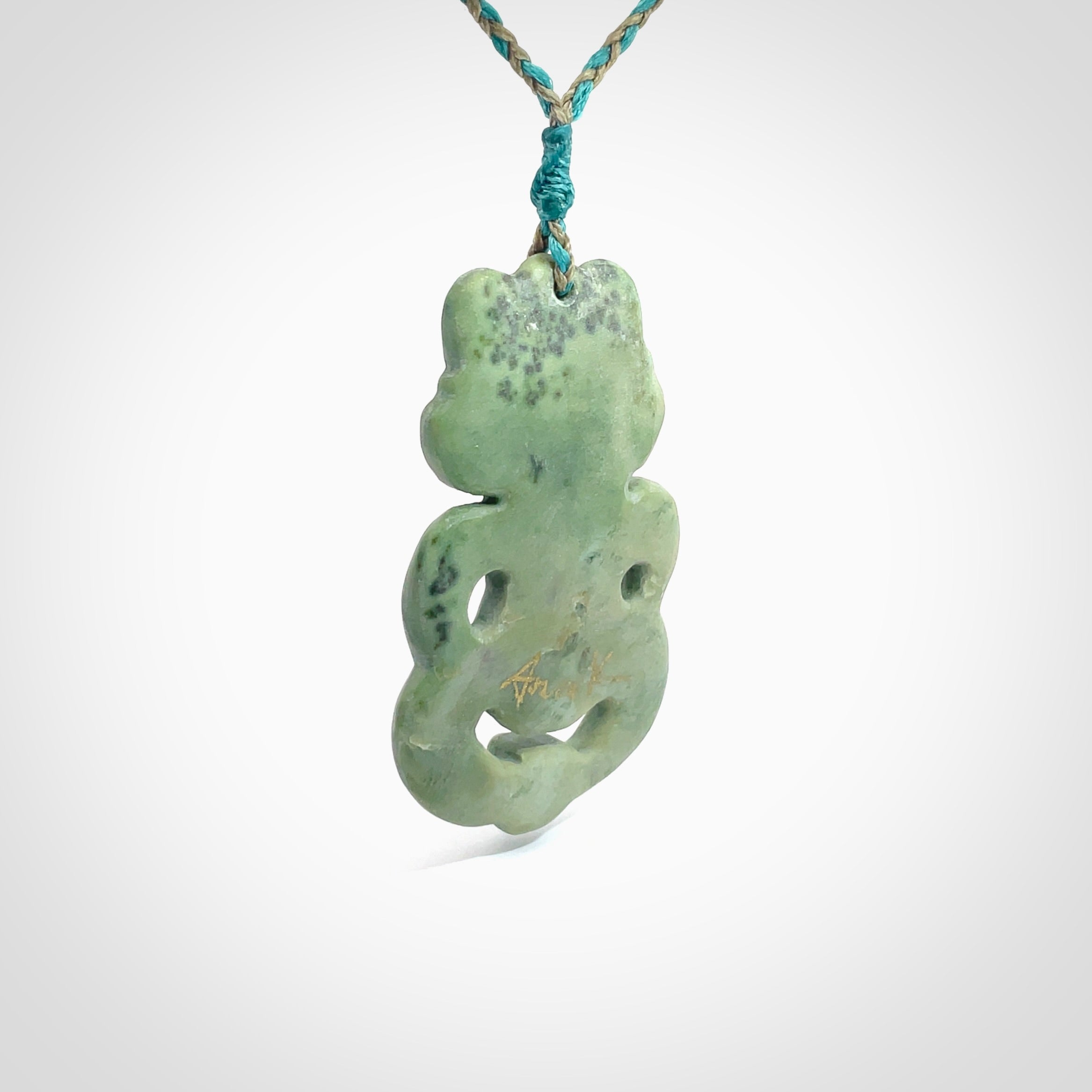 This is a large sized tiki - carved from gorgeous Marsden jade. The craftsmanship is superb, this piece is as well carved as any we have seen. The cord is an adjustable four plaited cord in black. One only by Ana Krakosky.