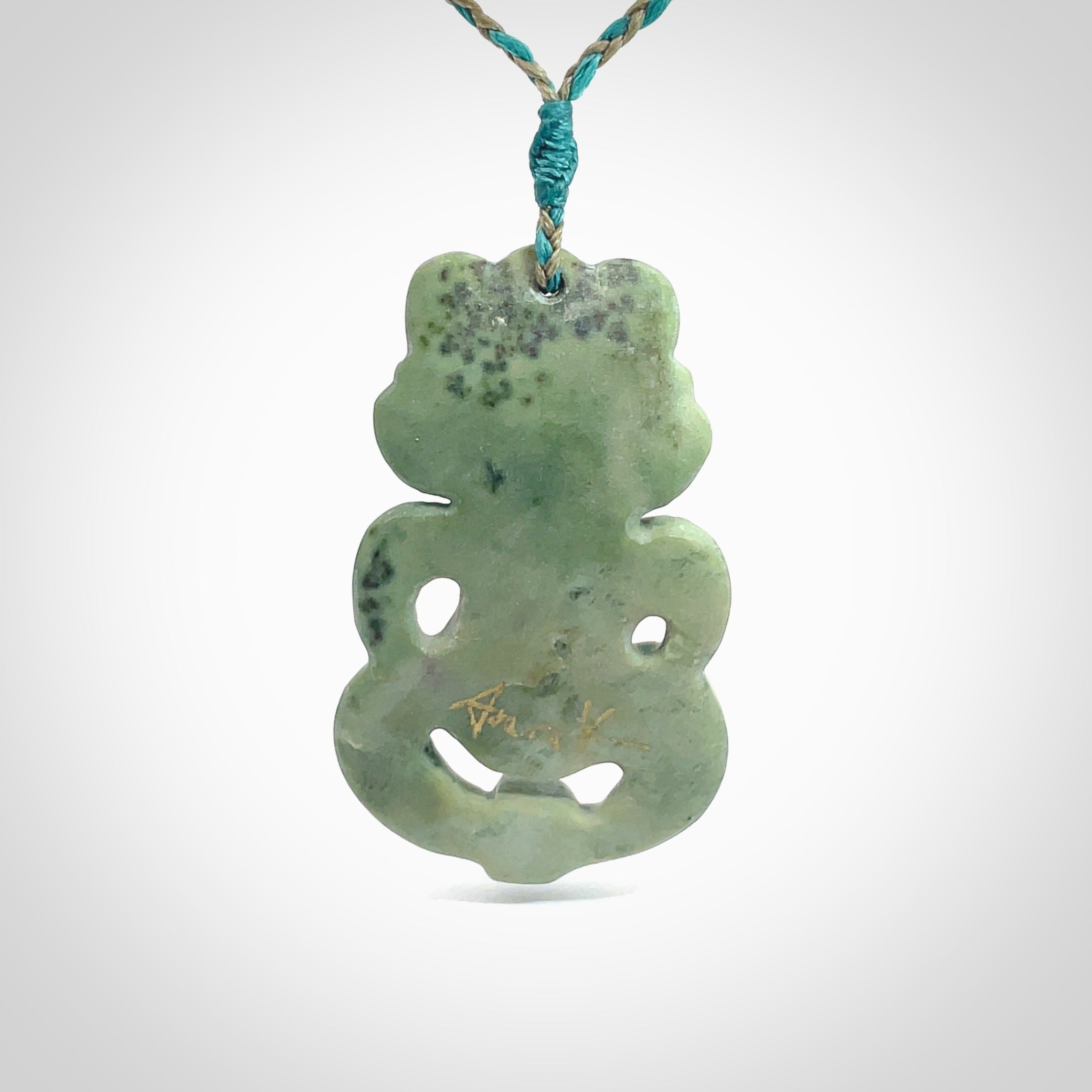 This is a large sized tiki - carved from gorgeous Marsden jade. The craftsmanship is superb, this piece is as well carved as any we have seen. The cord is an adjustable four plaited cord in black. One only by Ana Krakosky.