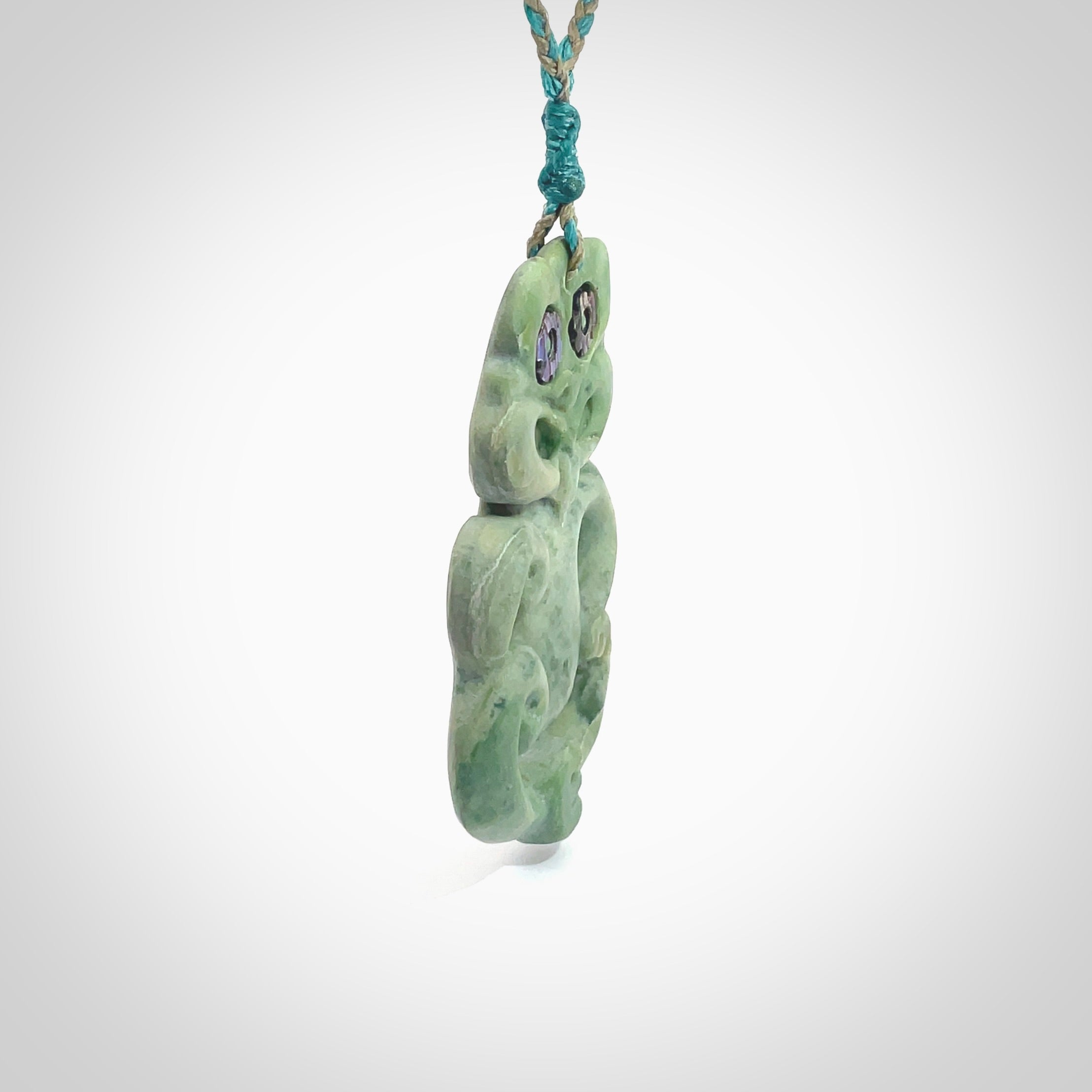 This is a large sized tiki - carved from gorgeous Marsden jade. The craftsmanship is superb, this piece is as well carved as any we have seen. The cord is an adjustable four plaited cord in black. One only by Ana Krakosky.